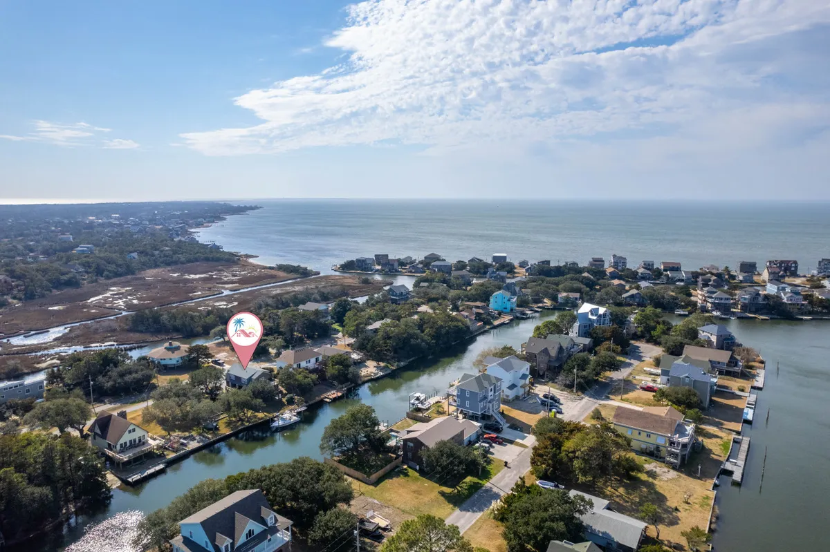 This wide view captures a peaceful canal edged with waterfront homes, boats, and surrounding greenery. The scene suggests opportunities for boating, fishing, and nature walks, perfectly fitting the narrative of family exploration and outdoor bonding.
