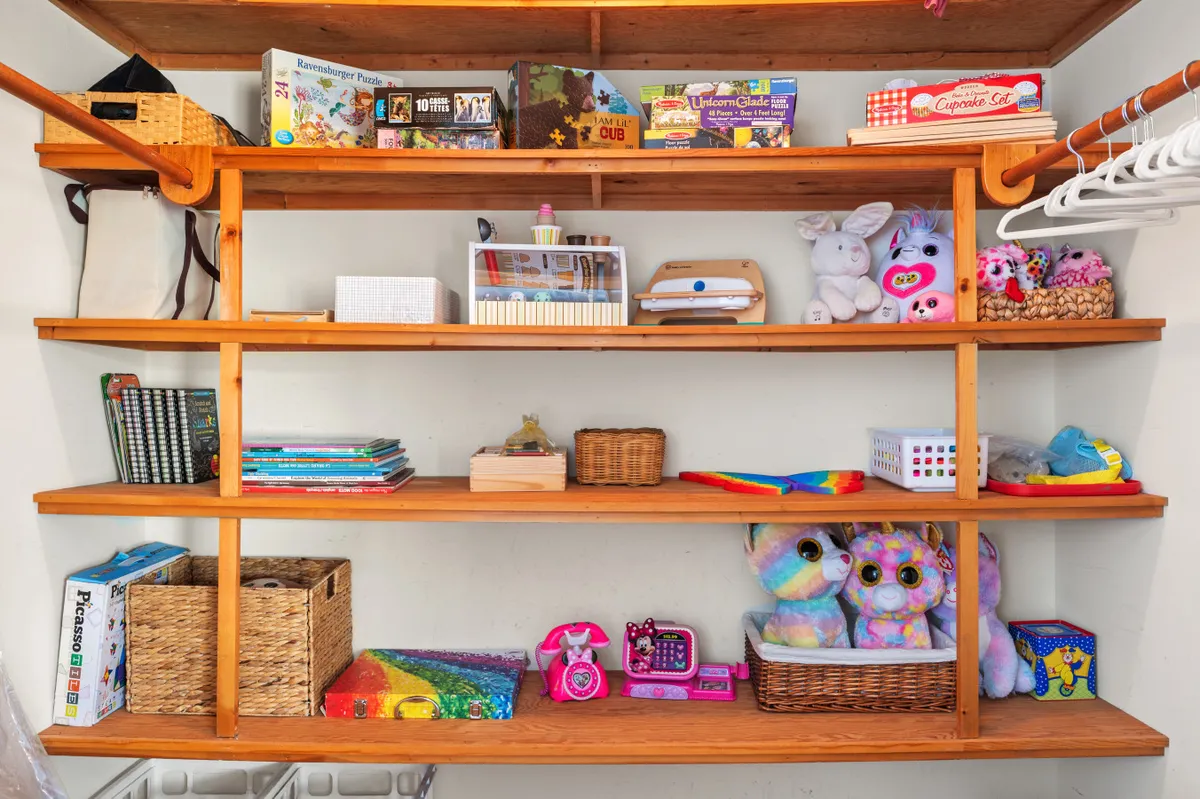 A cheerful play area filled with colorful toys, puzzles, stuffed animals, and books, inviting for children of all ages. The setup suggests a family-friendly environment with thoughtful provisions for kids.